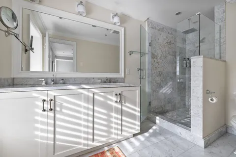a bathroom with a shower and a sink