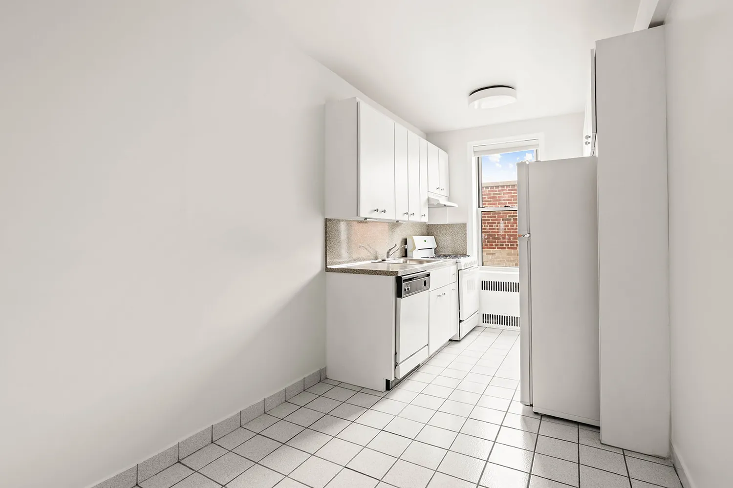 a kitchen with white cabinets and white appliances