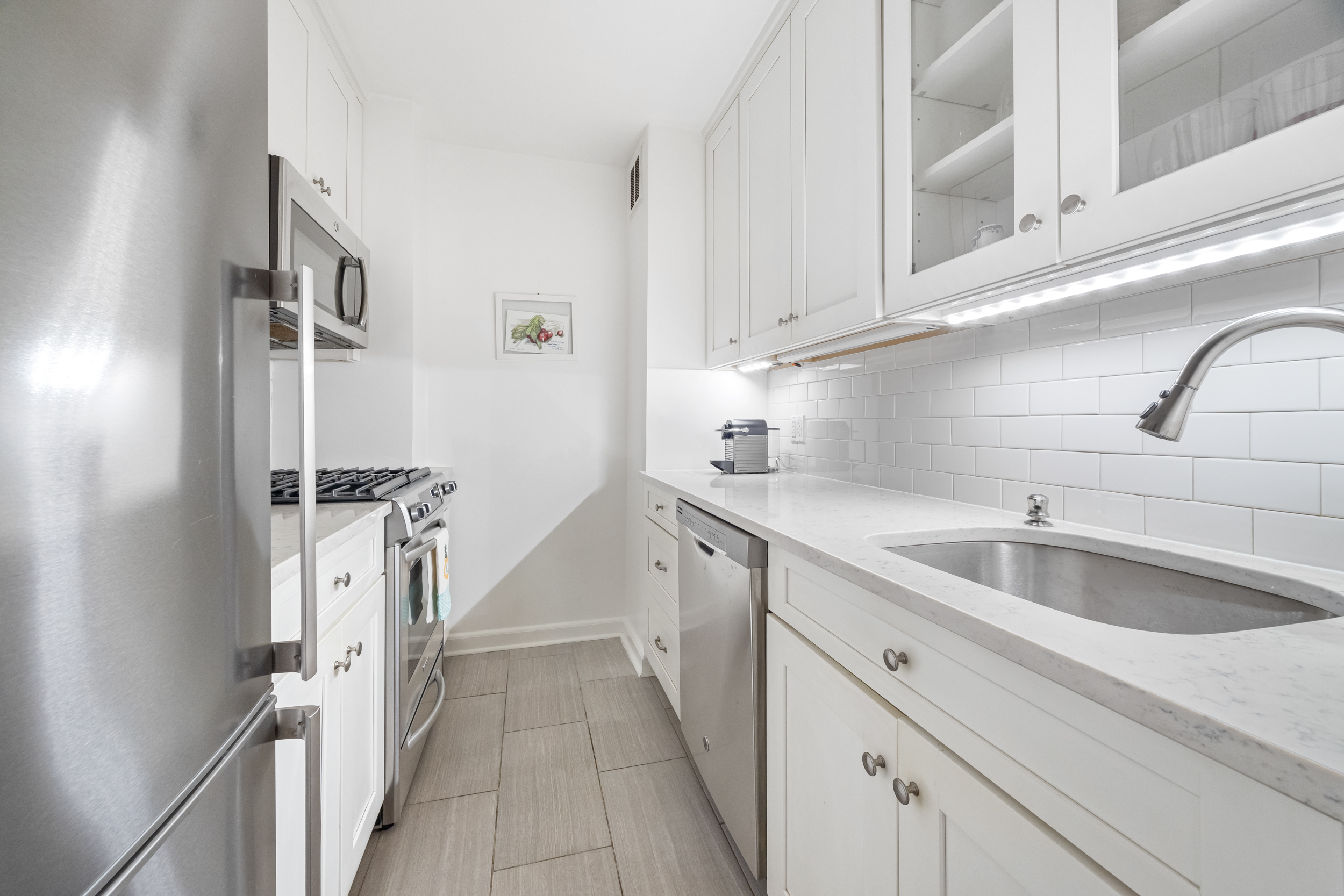 2 5th Avenue, Unit 2R Manhattan, NY 10011 - Photo 6 of 12 a kitchen with a sink and cabinets