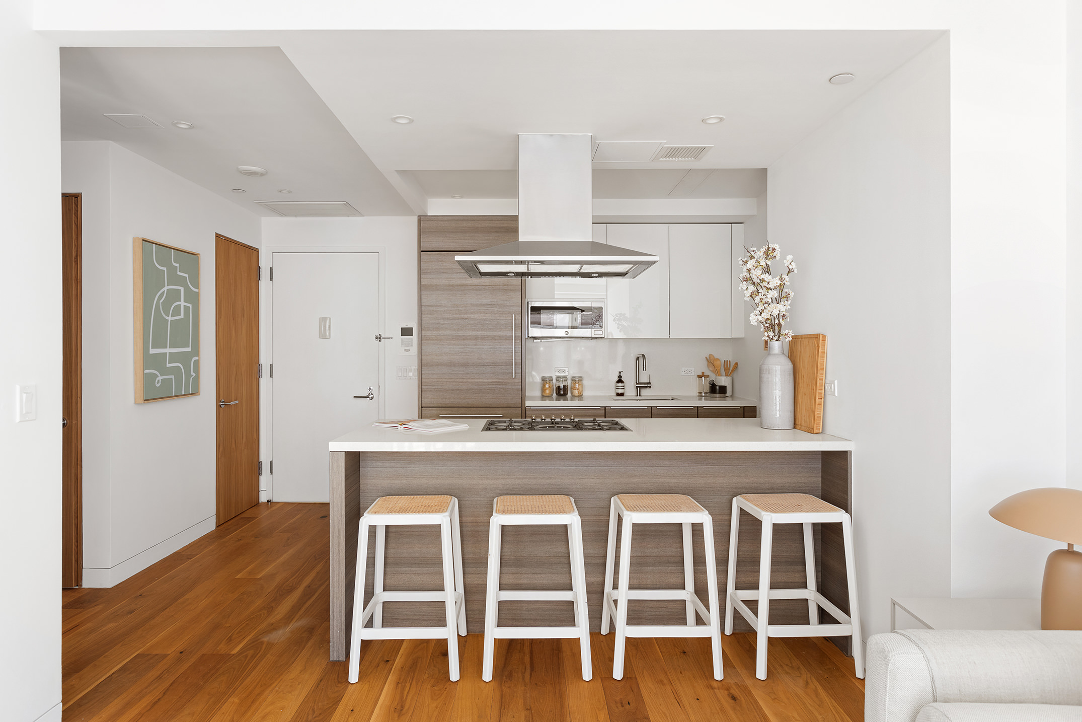 151 West 21st Street, Unit 9C Manhattan, NY 10011 - Photo 4 of 10 a kitchen with cabinets and wooden floor