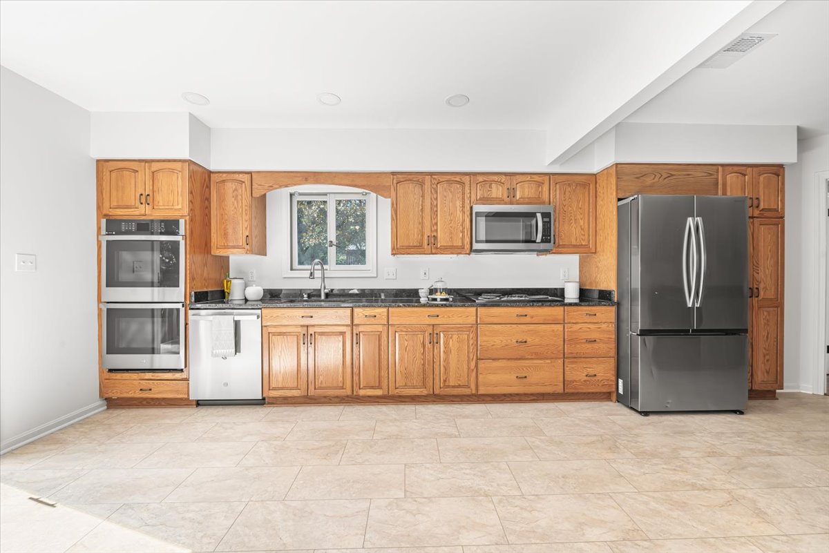 1902 Rookwood Road Silver Spring, MD 20910 - Photo 14 of 36 a kitchen with stainless steel appliances granite countertop a refrigerator sink and stove