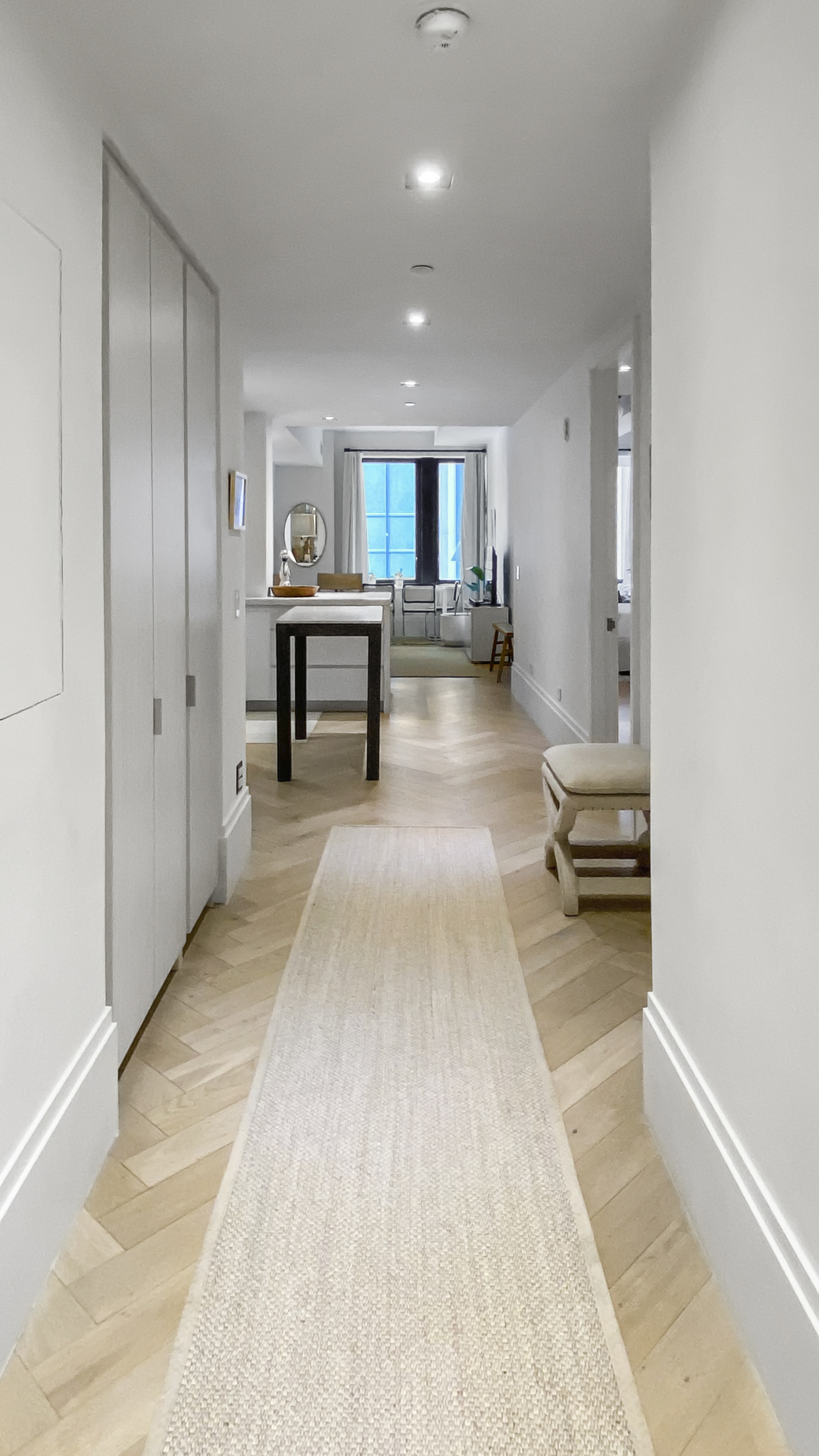 101 Wall Street, Unit 12C Manhattan, NY 10005 - Photo 5 of 18 a view of a hallway with a livingroom and furniture