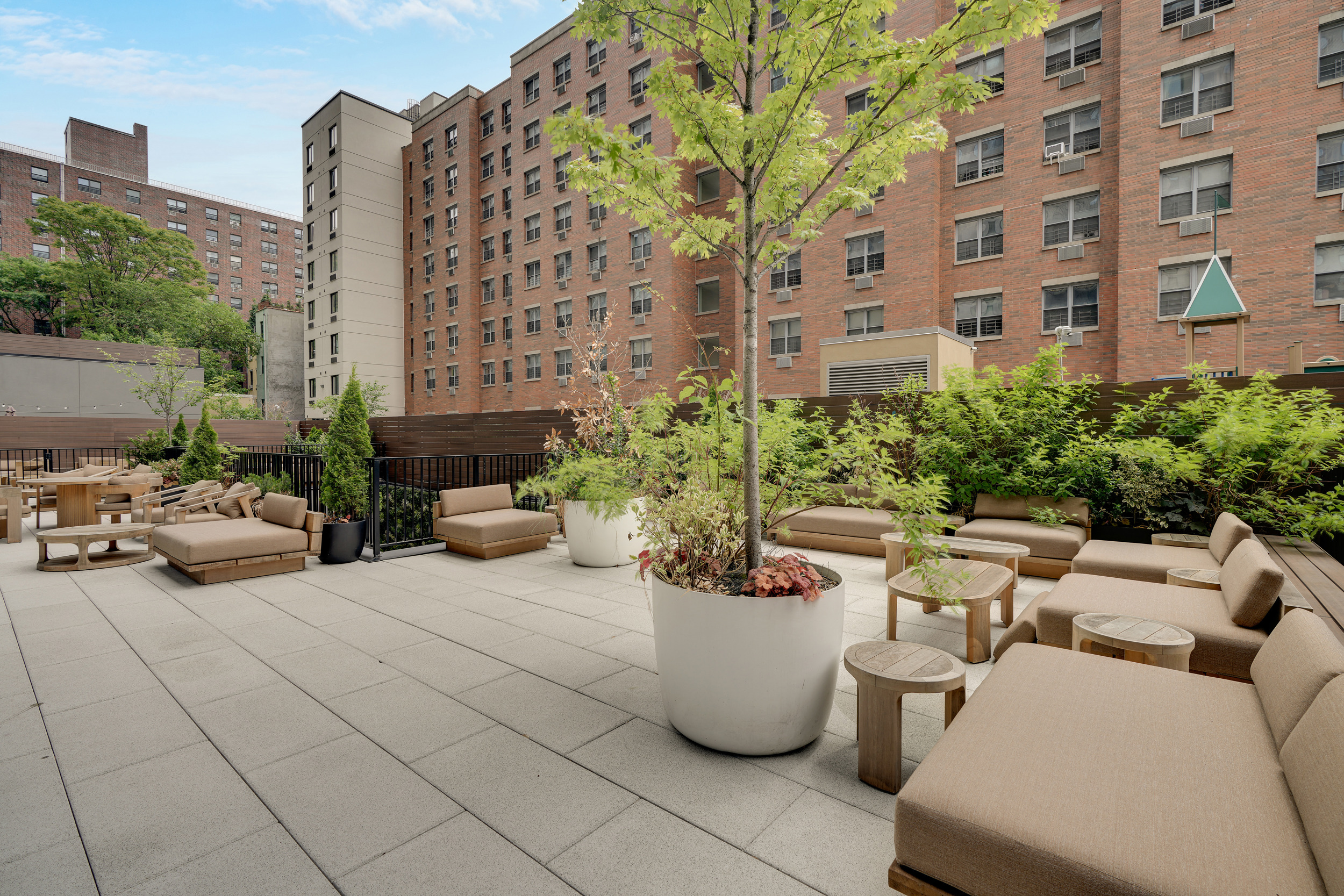 224 West 124th Street, Unit 1605 Manhattan, NY 10027 - Photo 19 of 23 a view of a patio with couches and a potted plant