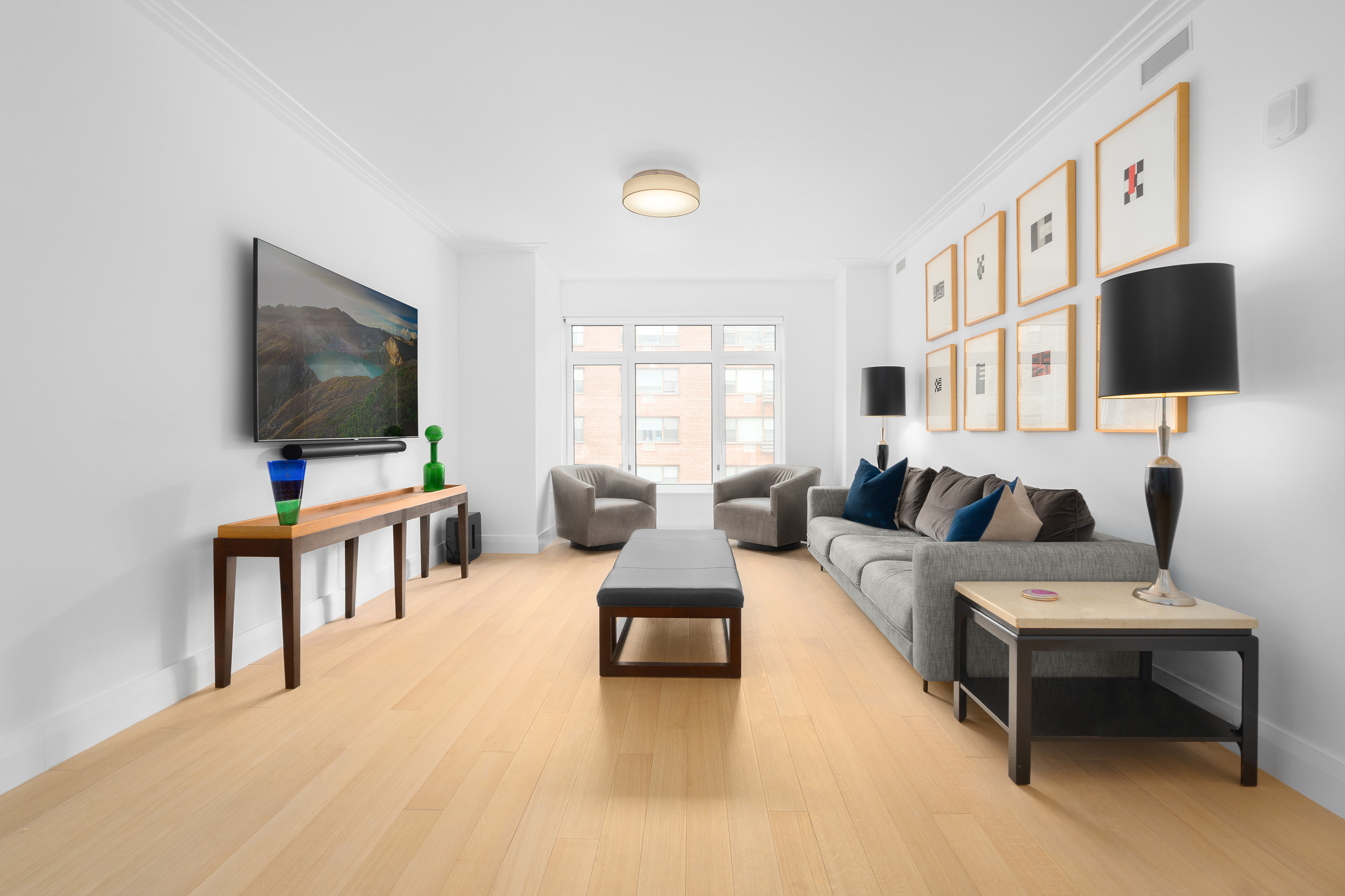 200 East 83rd Street, Unit 5D Manhattan, NY 10028 - Photo 2 of 29 a living room with furniture and a flat screen tv