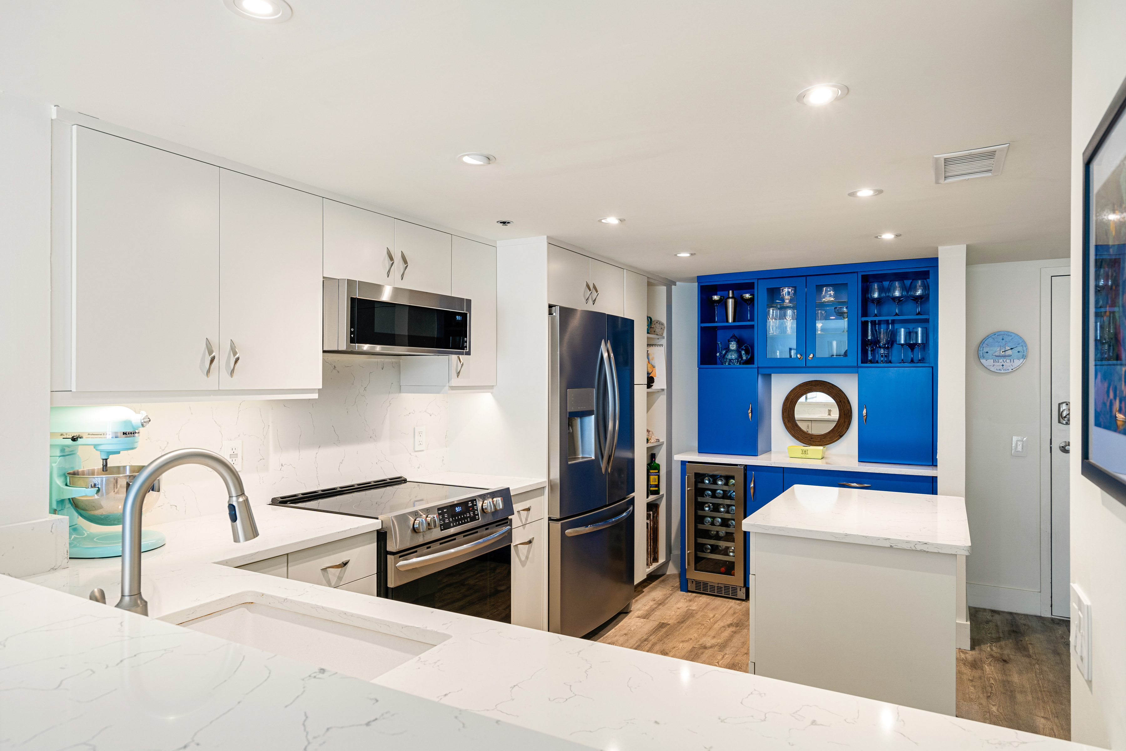 a kitchen with stainless steel appliances granite countertop a refrigerator sink and stove