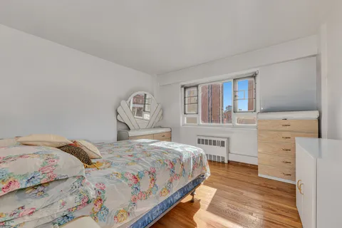 a bedroom with a bed and a table