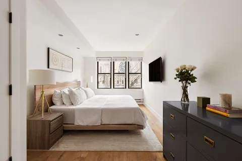 a bedroom with a bed and tv