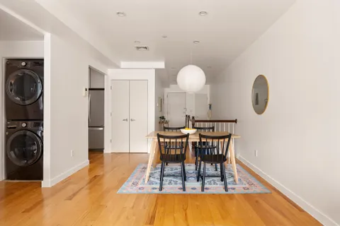a view of a room that has a table and chairs in it