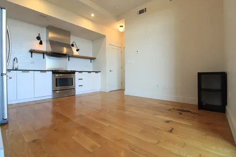 a view of a kitchen with a sink and a stove top oven