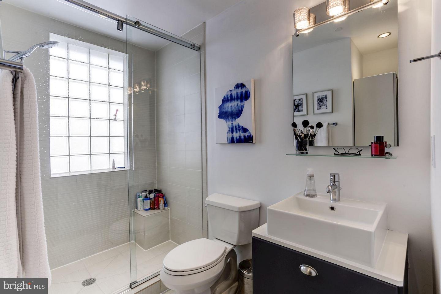 2426 Ontario Road Northwest, Unit 401 Washington, DC 20009 - Photo 5 of 28 a bathroom with a sink toilet and shower