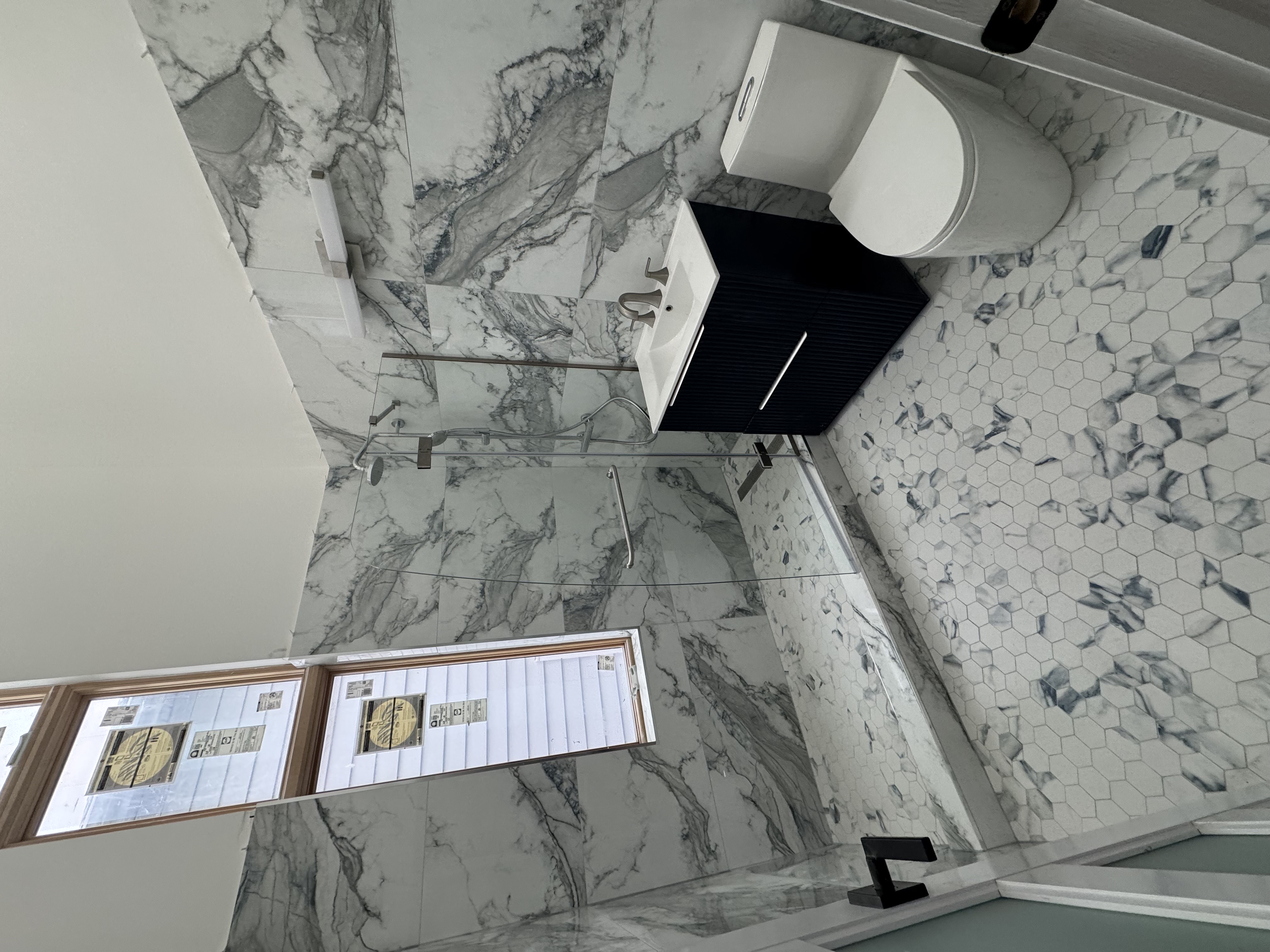 2813 Brown Street Brooklyn, NY 11235 - Photo 3 of 4 a bathroom with a toilet sink and mirror