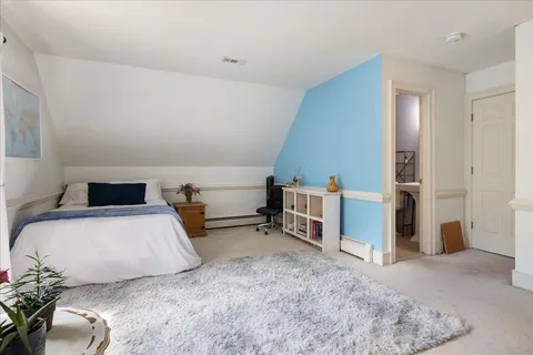a bathroom with a granite countertop double vanity sink a mirror and a bathtub