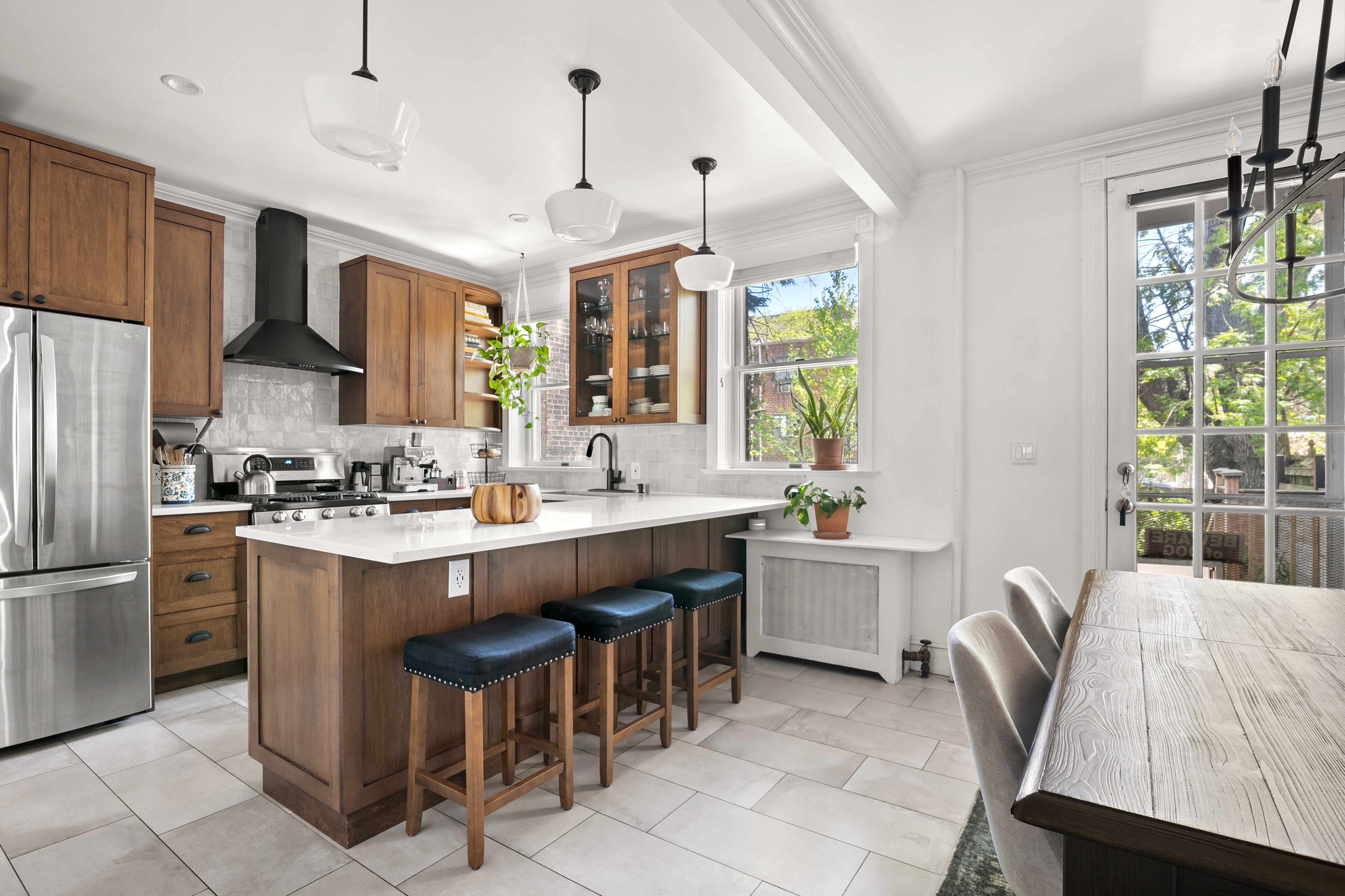 41-27 39th Place Queens, NY 11104 - Photo 2 of 13 a kitchen with cabinets a sink stainless steel appliances and window