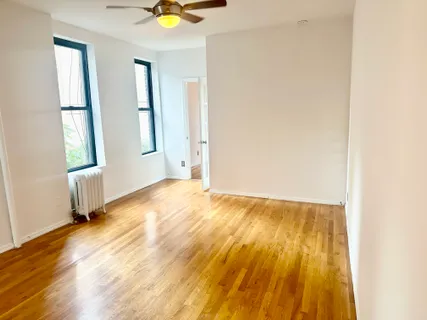 an empty room with windows and closet