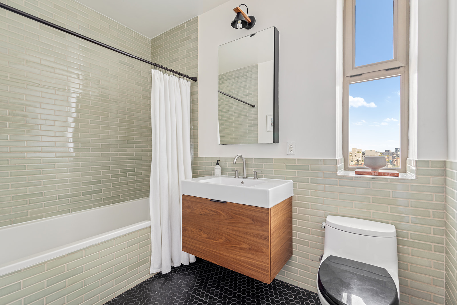 144 North 8th Street, Unit 8C Brooklyn, NY 11249 - Photo 7 of 13 a bathroom with a sink a toilet and bathtub