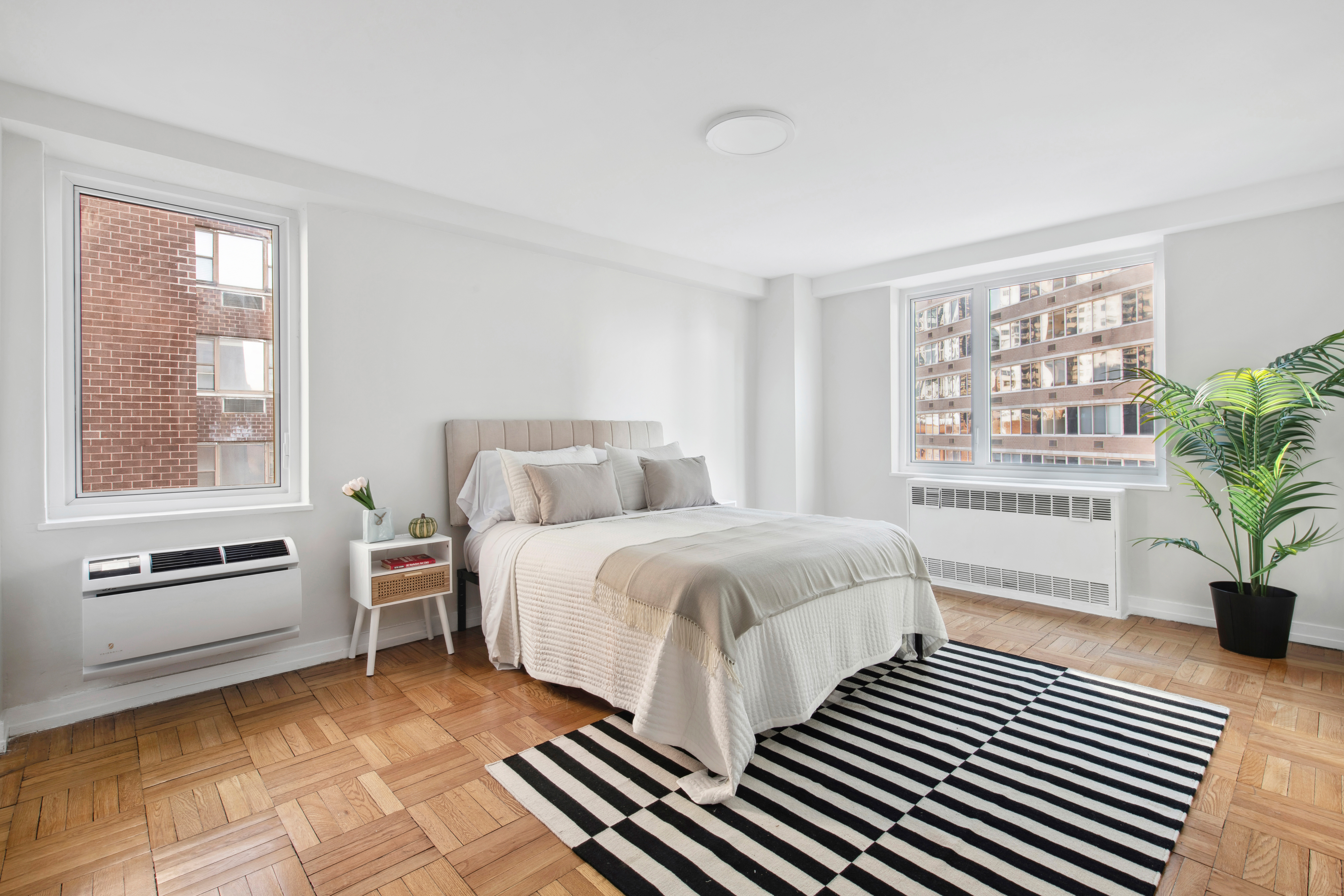 411 East 53rd Street, Unit 20A Manhattan, NY 10022 - Photo 6 of 12 a bedroom with a bed and windows