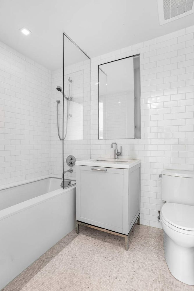182 West 82nd Street, Unit 4E Manhattan, NY 10024 - Photo 16 of 25 a bathroom with a bathtub a sink and a mirror
