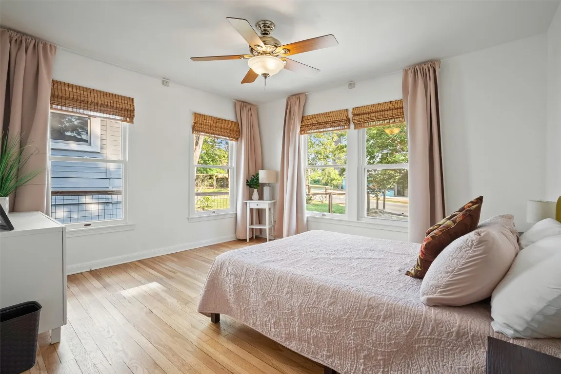 a bedroom with a bed and a large window