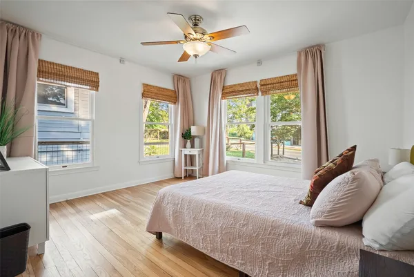 a bedroom with a bed and a large window