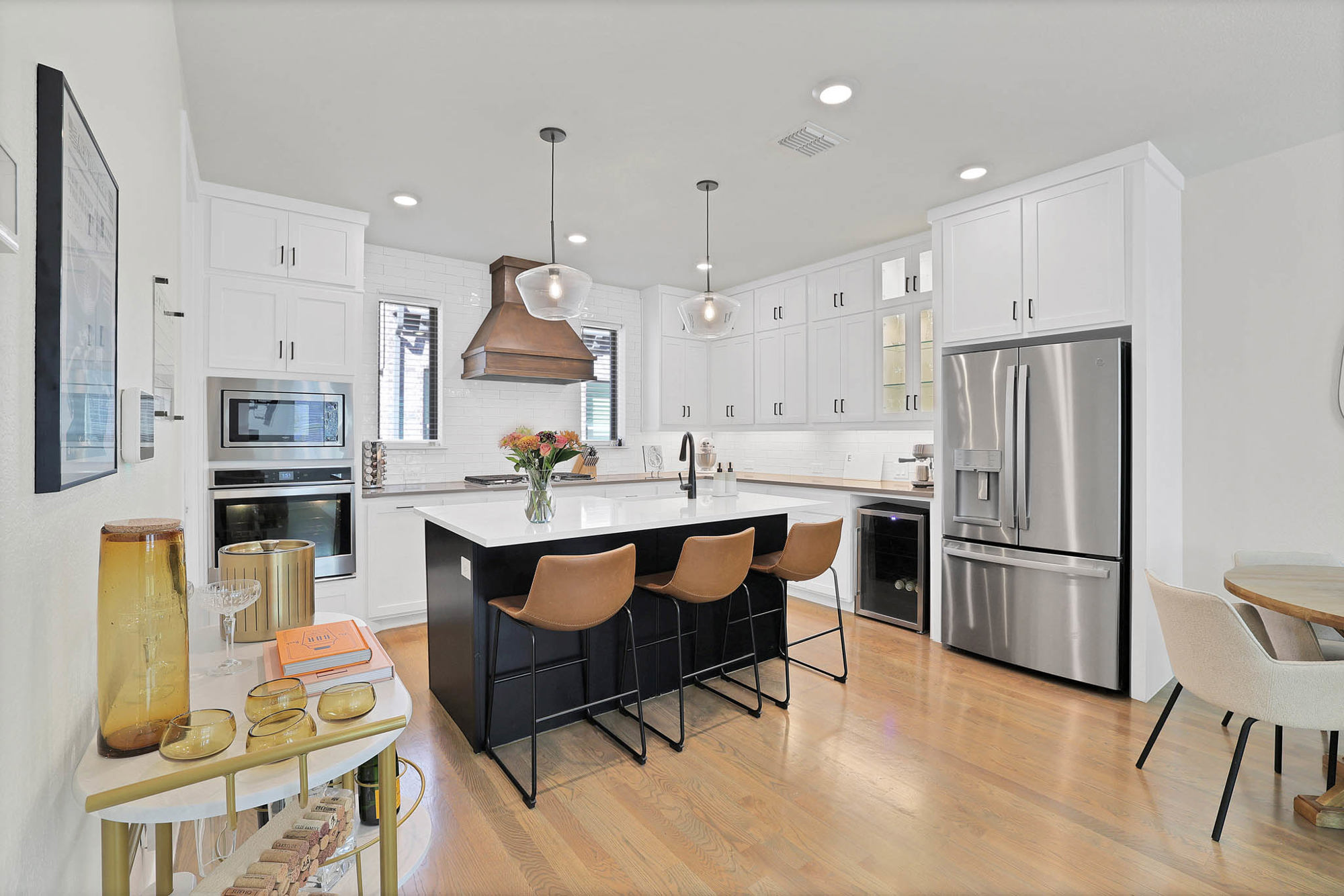 3920 Riesling Ridge Dallas, TX 75204 - Photo 3 of 26 a kitchen with stainless steel appliances granite countertop a refrigerator a sink a stove a dining table and chairs with wooden floor