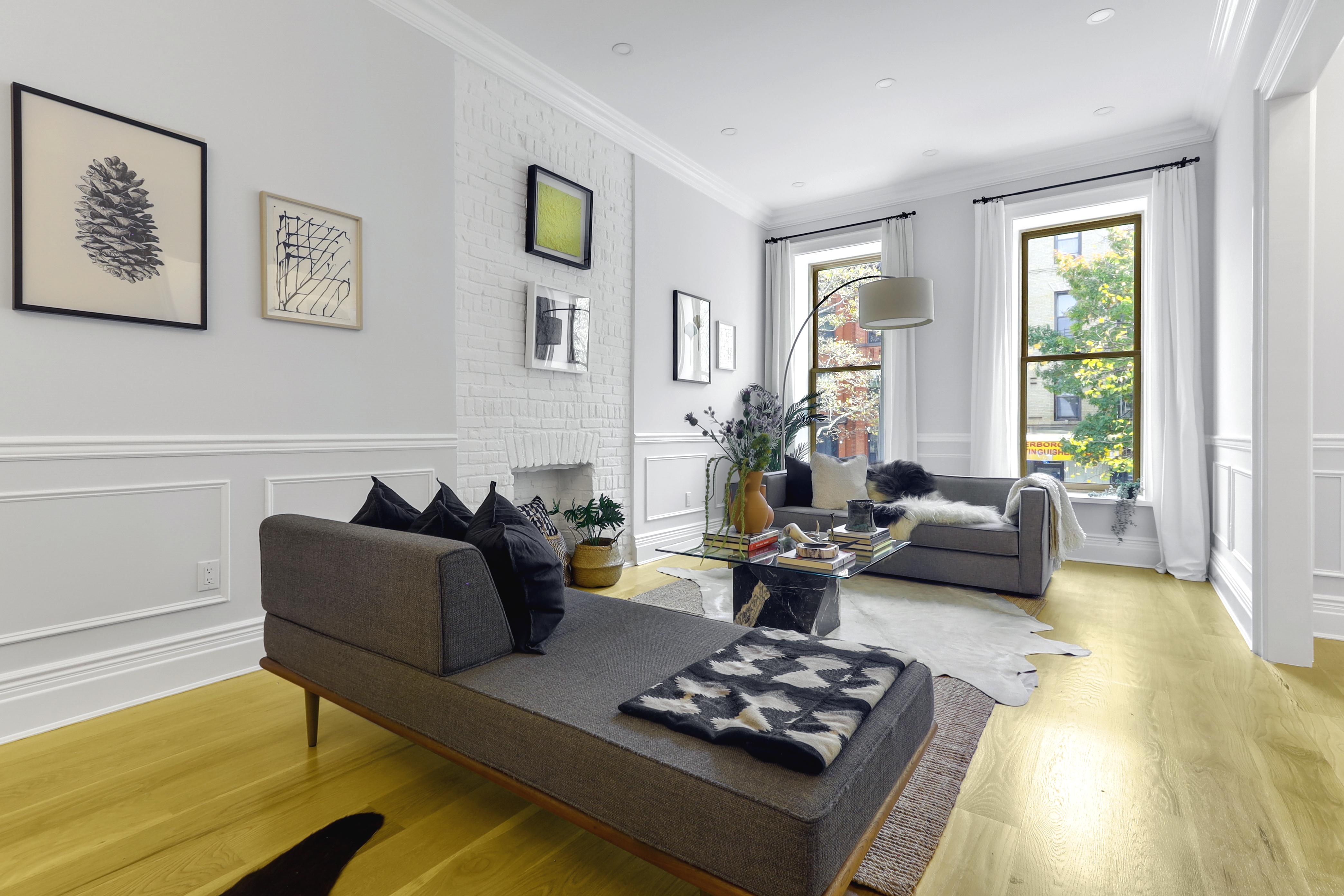 220 Lewis Avenue Brooklyn, NY 11221 - Photo 2 of 22 a living room with furniture couches and a large window with wooden floor