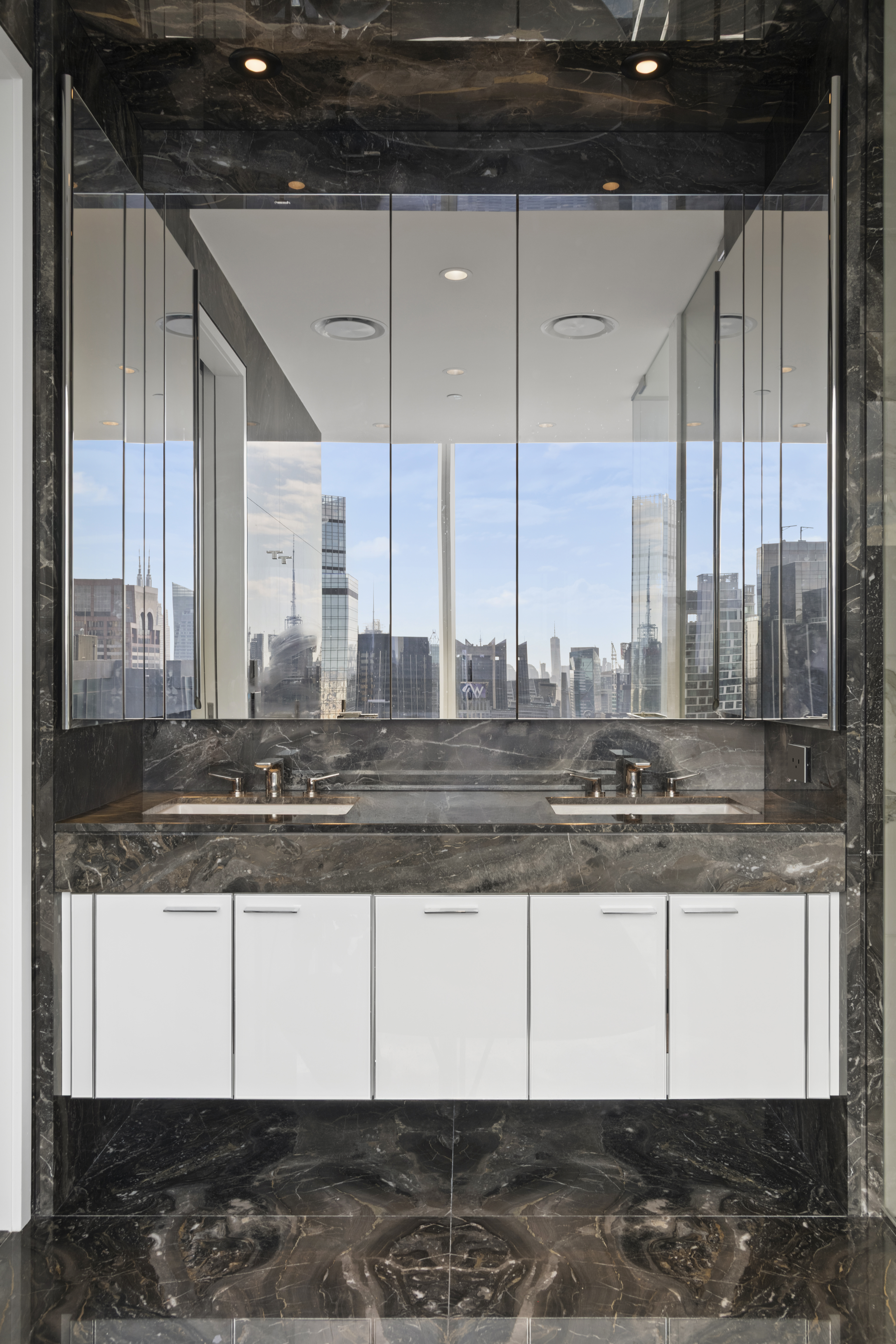 217 West 57th Street, Unit 58W Manhattan, NY 10019 - Photo 15 of 30 a kitchen with stainless steel appliances granite countertop a sink and a counter