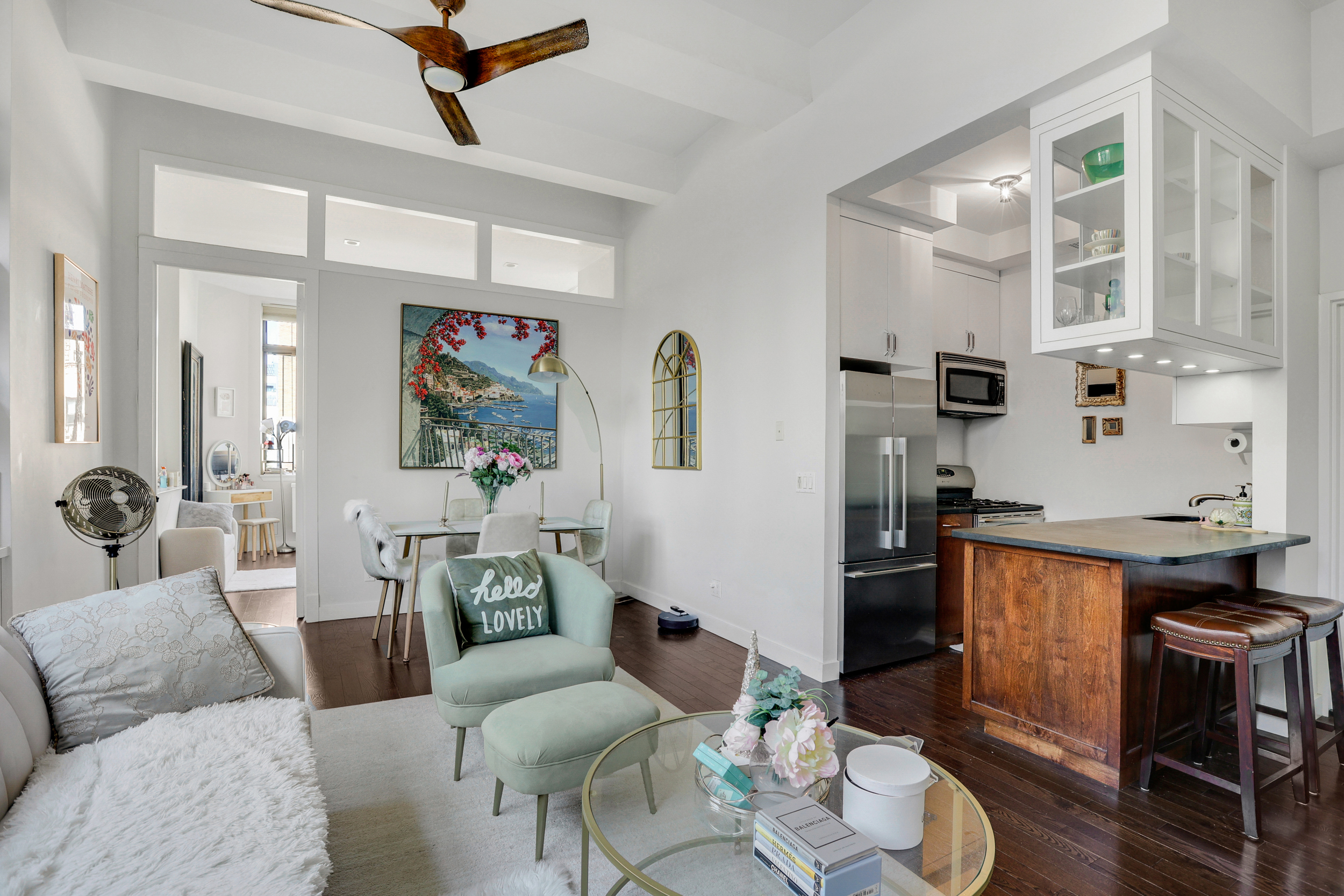 310 East 46th Street, Unit 16B Manhattan, NY 10017 - Photo 4 of 7 a living room with furniture and wooden floor