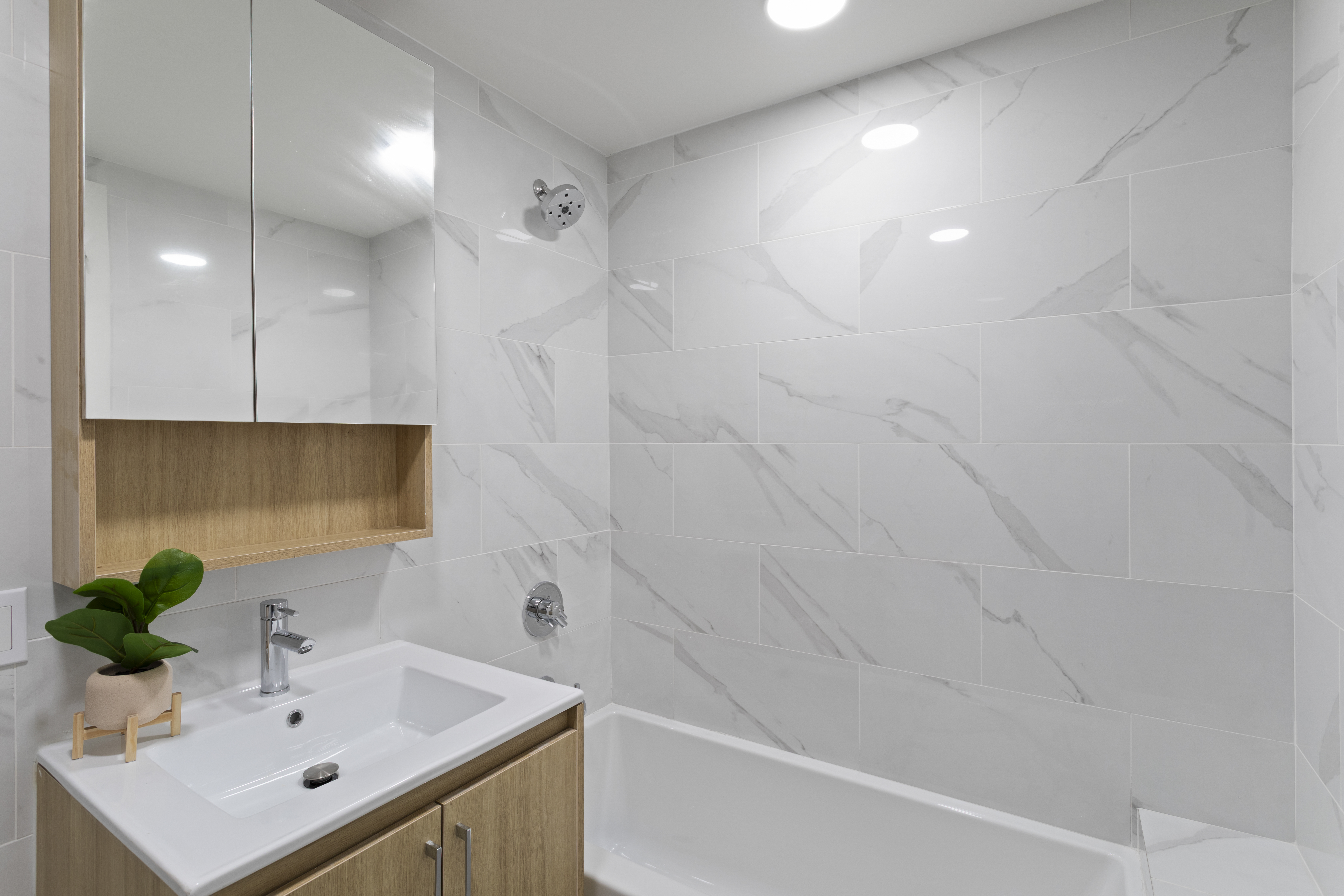 3112 Emmons Avenue, Unit 104 Brooklyn, NY 11235 - Photo 8 of 12 a bathroom with a sink a toilet and shower