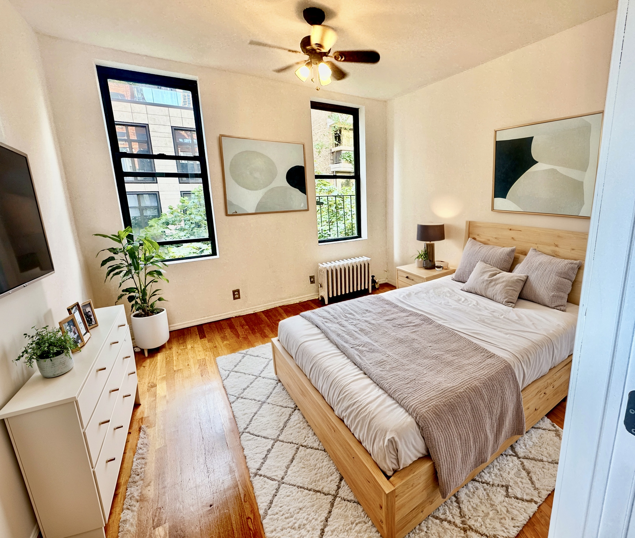 246 East 51st Street, Unit 22 Manhattan, NY 10022 - Photo 3 of 9 a bedroom with a large bed and a chandelier