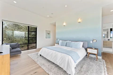 a bedroom with a large bed and a large window
