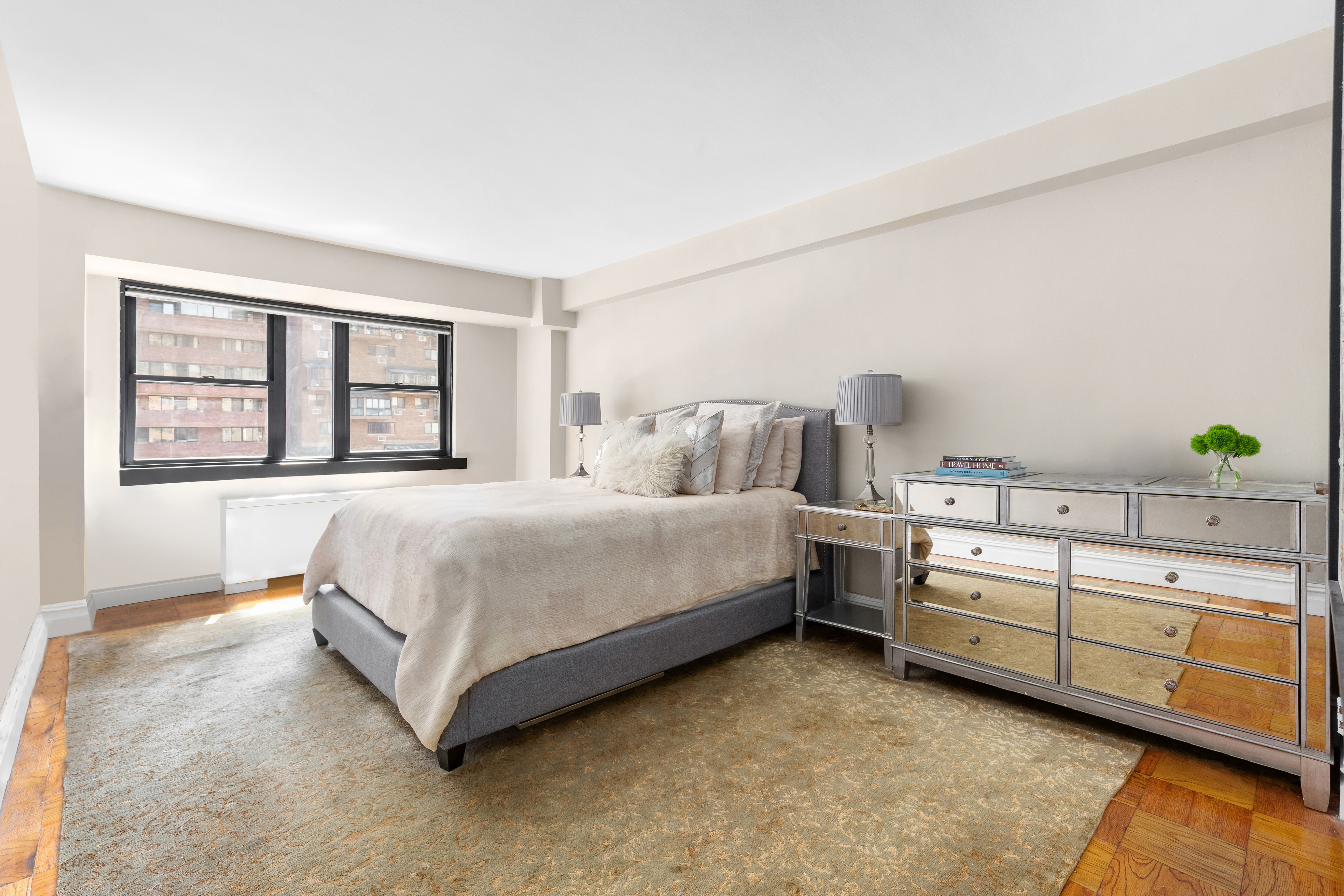 235 East 87th Street, Unit 10B Manhattan, NY 10128 - Photo 6 of 12 a spacious bedroom with a bed and a window