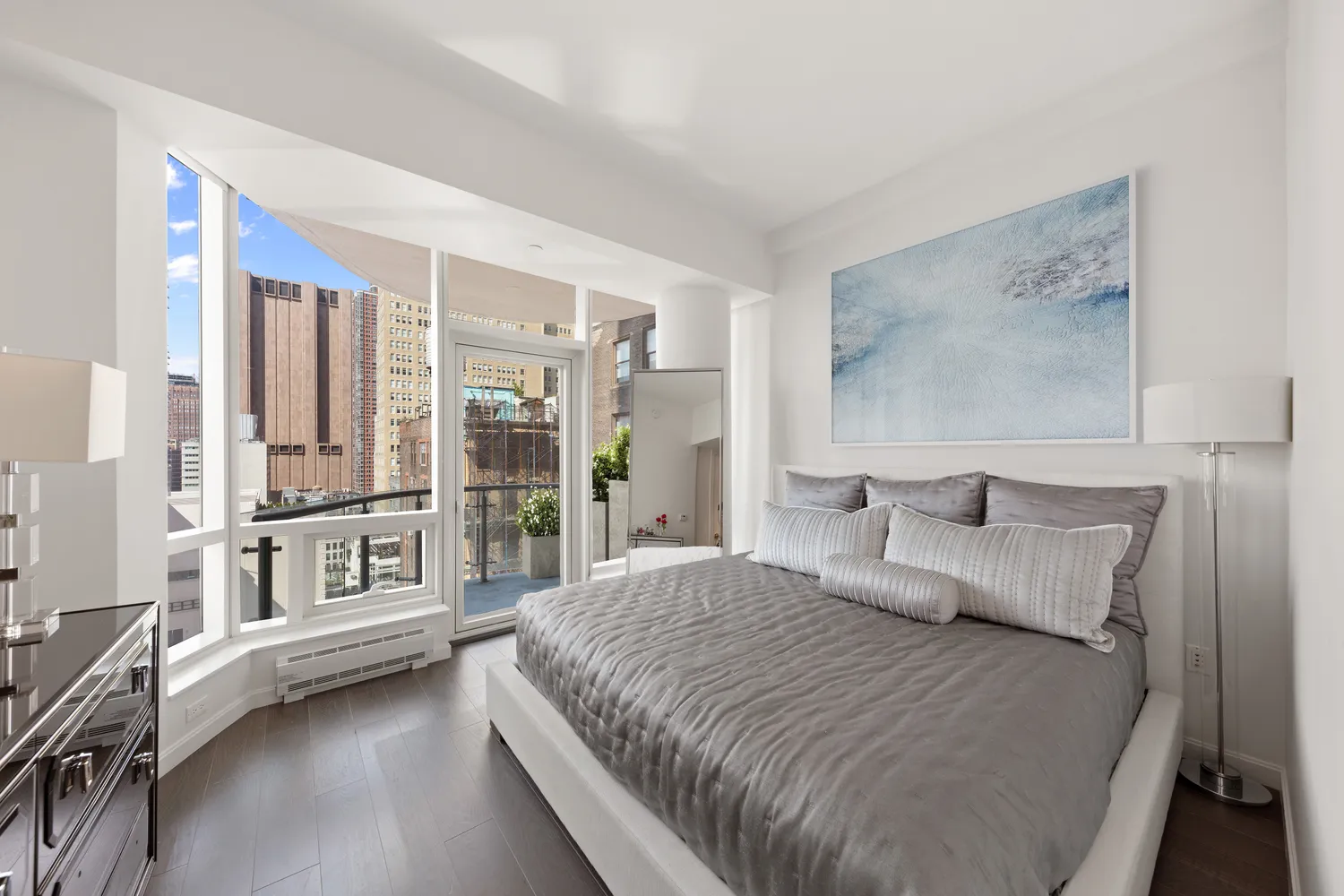 a bedroom with a large bed and a large window with outer view