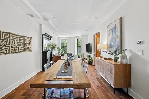 a view of a dining room with furniture window and wooden floor