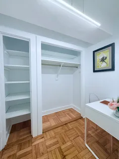 a bedroom with a bed and cabinets