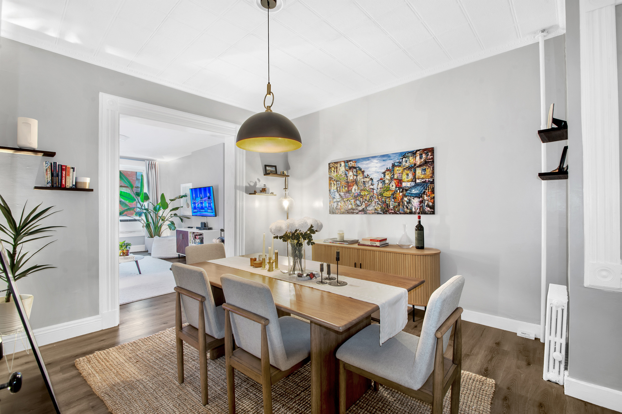 545 10th Street Brooklyn, NY 11215 - Photo 2 of 11 a view of a dining room and livingroom with furniture wooden floor a rug a potted plant and a chandelier