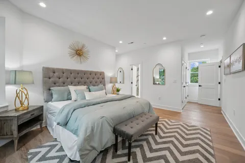 a spacious bedroom with a bed and a chandelier