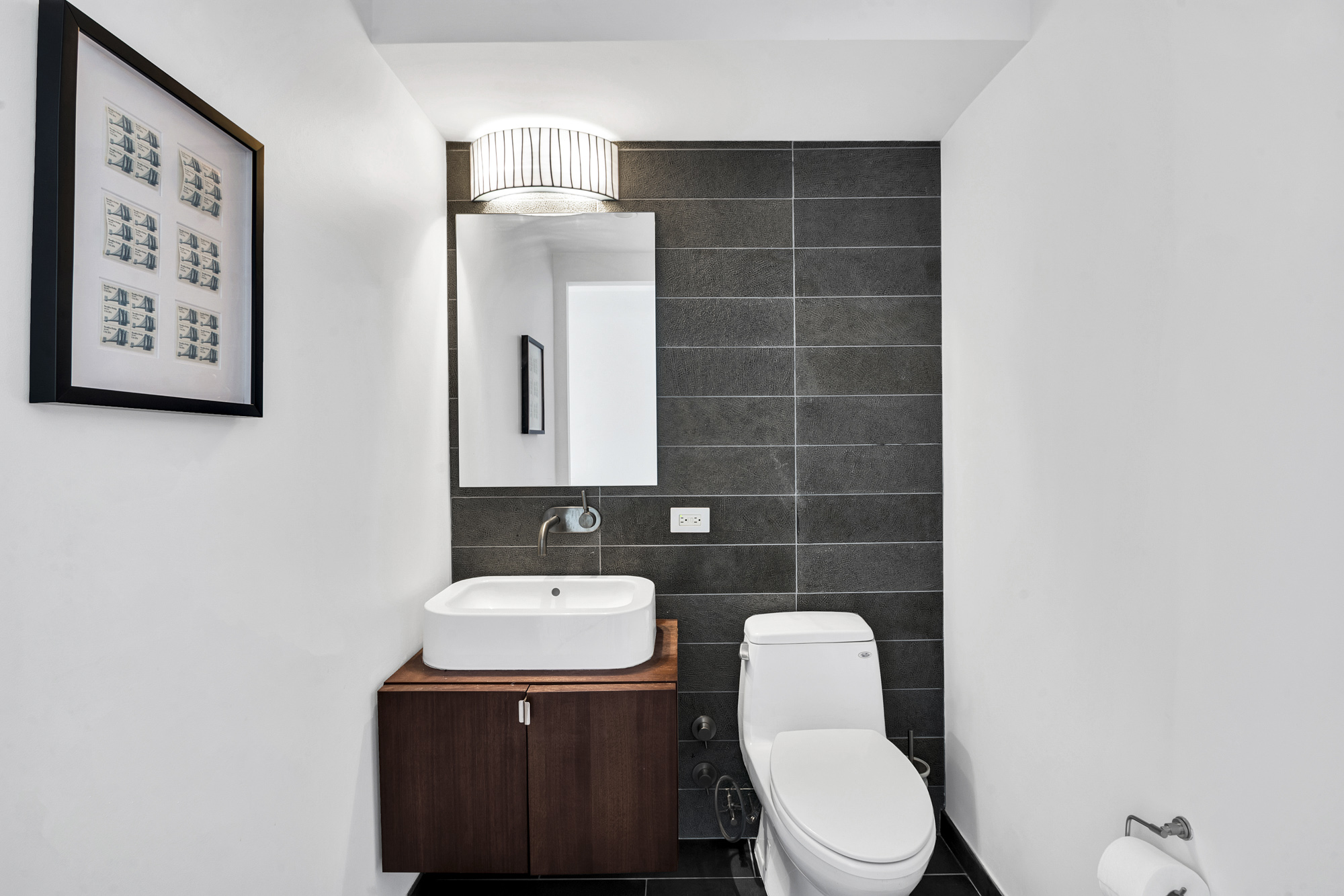 2280 Frederick Douglass Boulevard, Unit 10B Manhattan, NY 10027 - Photo 13 of 15 a bathroom with a toilet sink and mirror