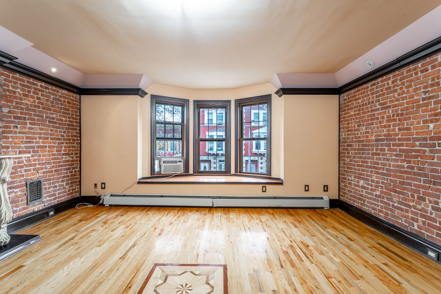 12 Virginia Place Brooklyn, NY 11213 - Photo 2 of 10 a view of empty room with wooden floor and fan