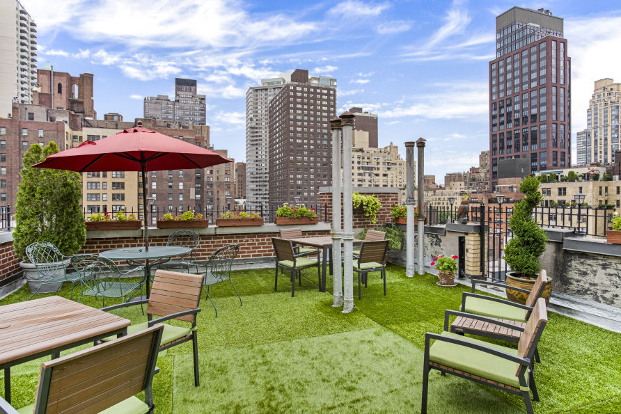 321 East 54th Street, Unit 1D Manhattan, NY 10022 - Photo 6 of 7 a swimming pool with outdoor seating and yard