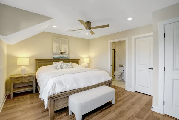 a bedroom with a bed and wooden floor