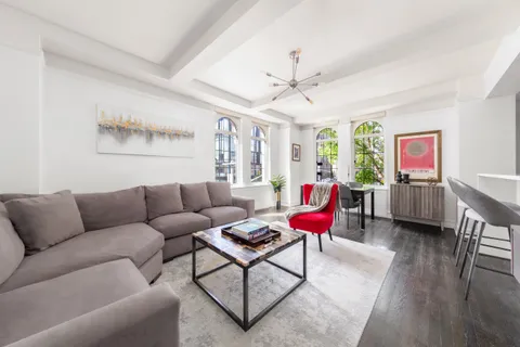 a living room with furniture kitchen view and a large window