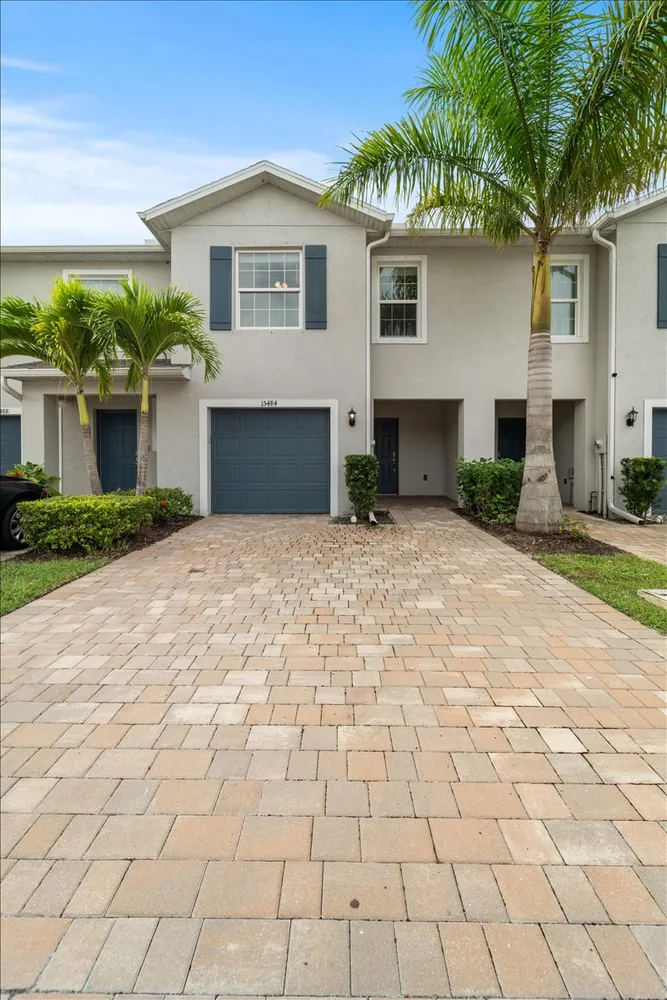 a front view of a house with a yard and a garage