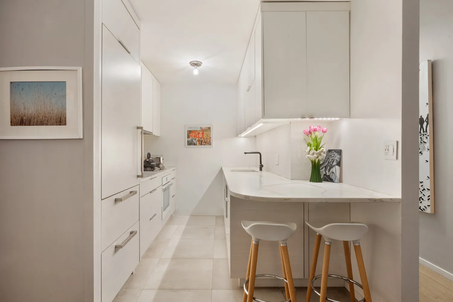 a kitchen with white cabinets and table