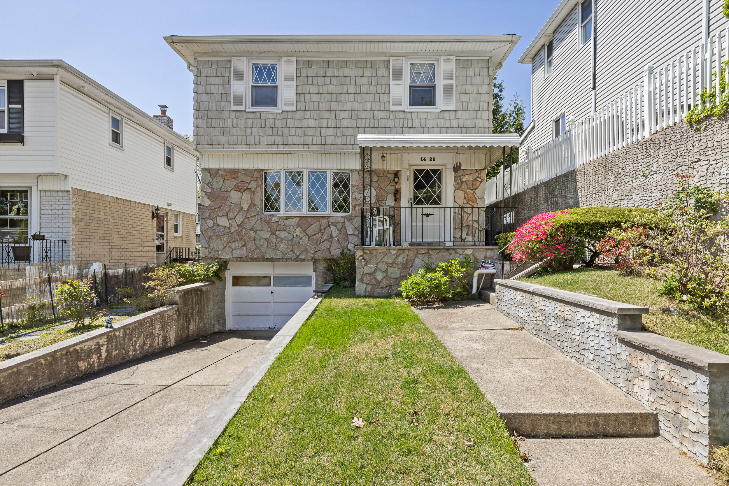 a front view of a house with a garden
