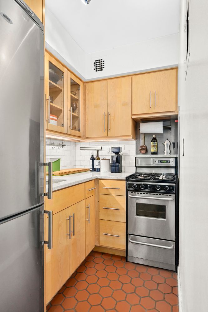 344 West End Avenue, Unit 6 Manhattan, NY 10024 - Photo 2 of 6 a kitchen with stainless steel appliances a stove sink and cabinets