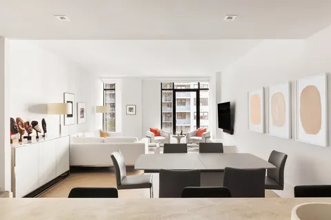 a living room with furniture a flat screen tv and a window