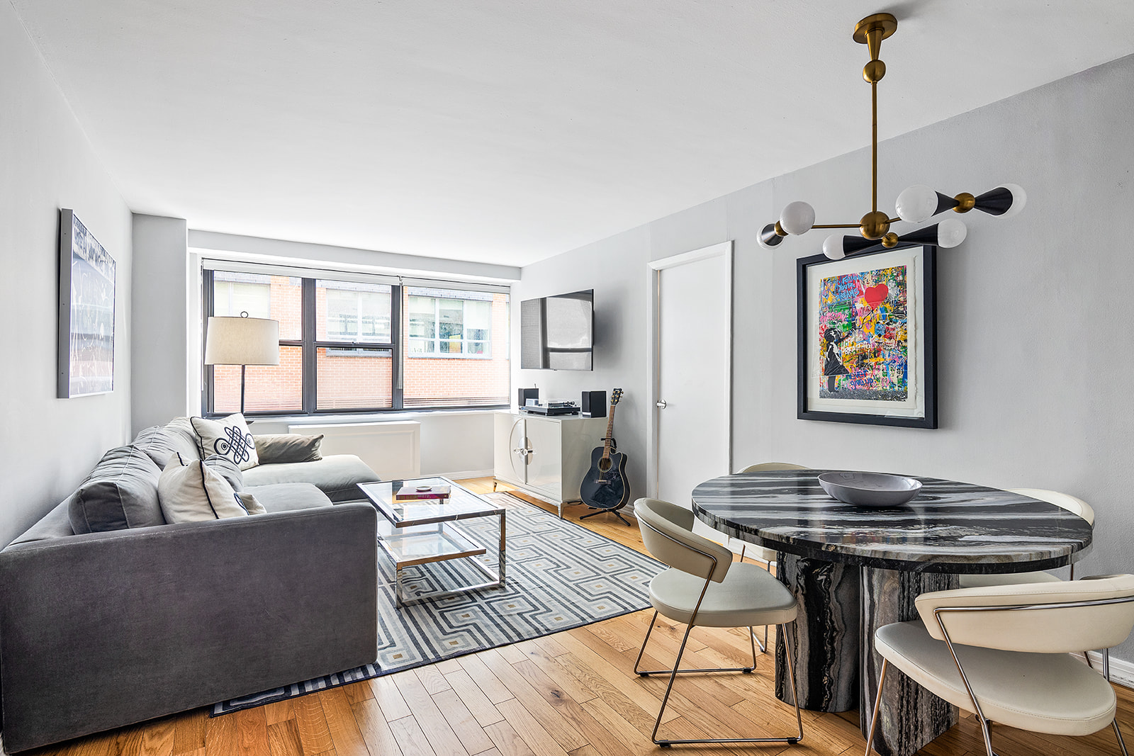 7 East 14th Street, Unit 429 Manhattan, NY 10003 - Photo 1 of 6 a living room with furniture and a window