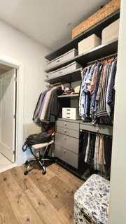 a view of walk in closet with clothes and shoes