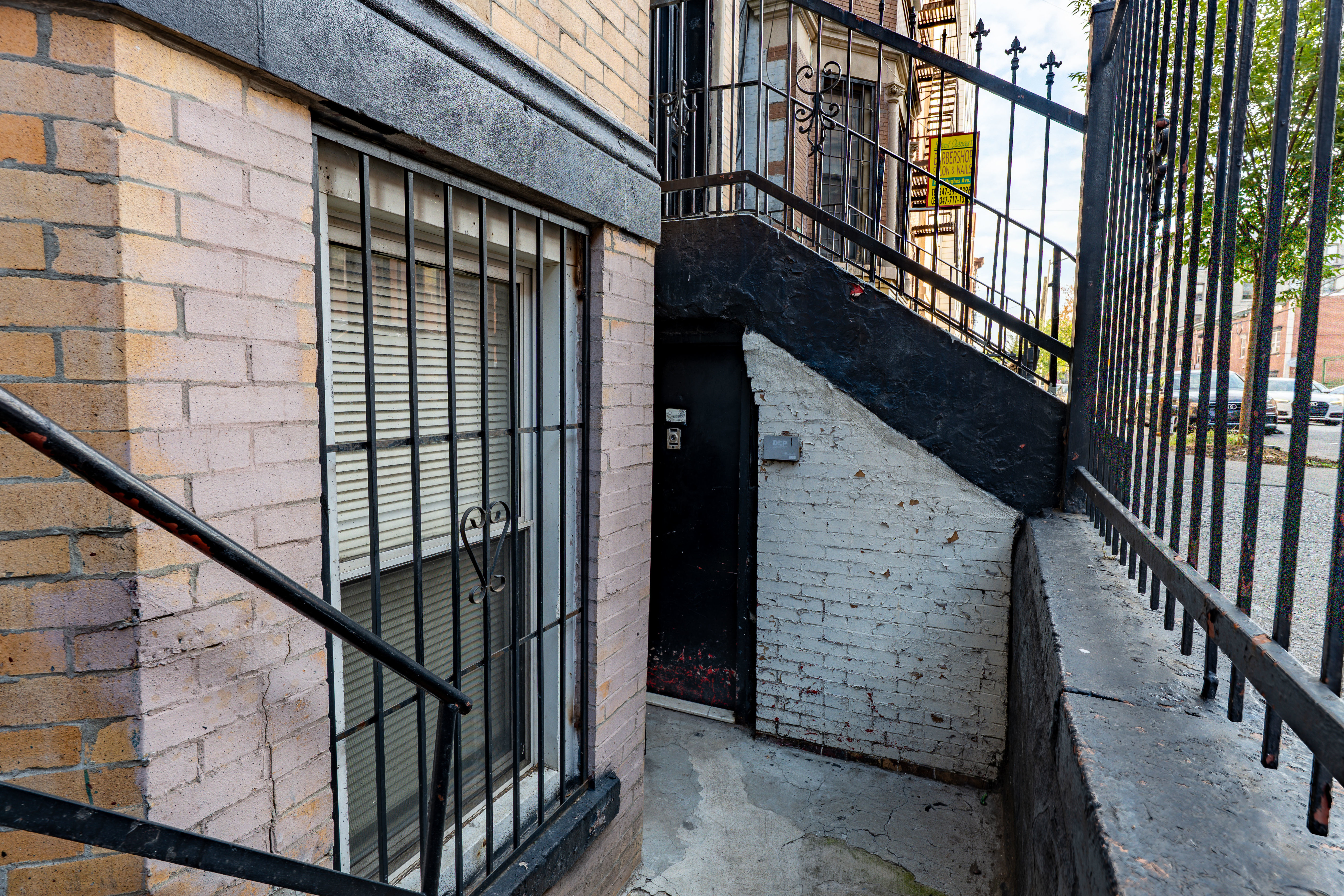 2023 Hughes Avenue Bronx, NY 10457 - Photo 22 of 63 a view of staircase with railing and white walls