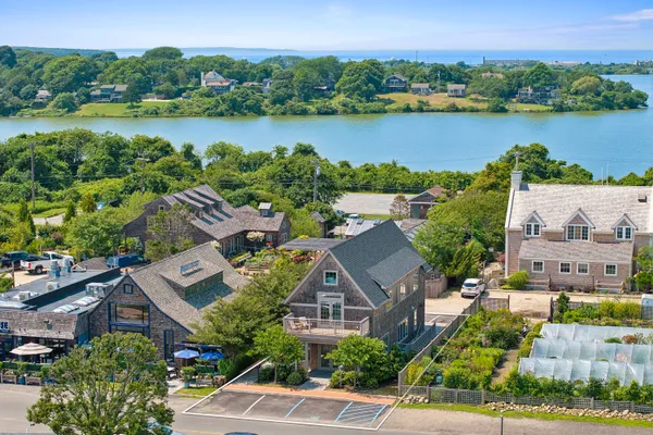 an aerial view of a house with outdoor space and lake view